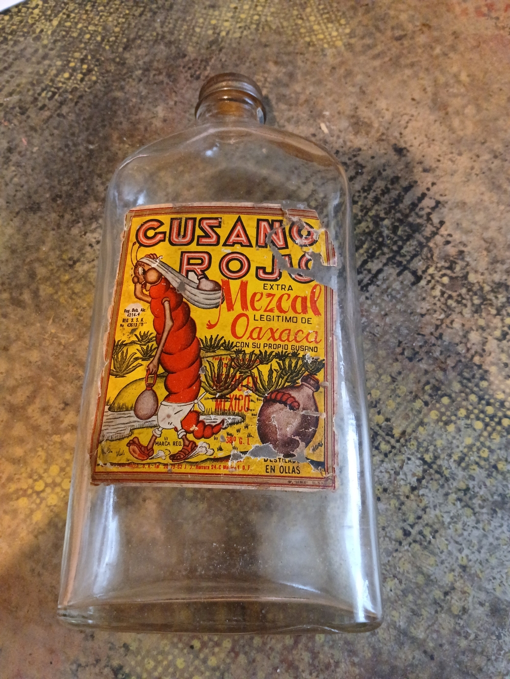 Vintage Mezcal Bottle with Bright Yellow and Red Label